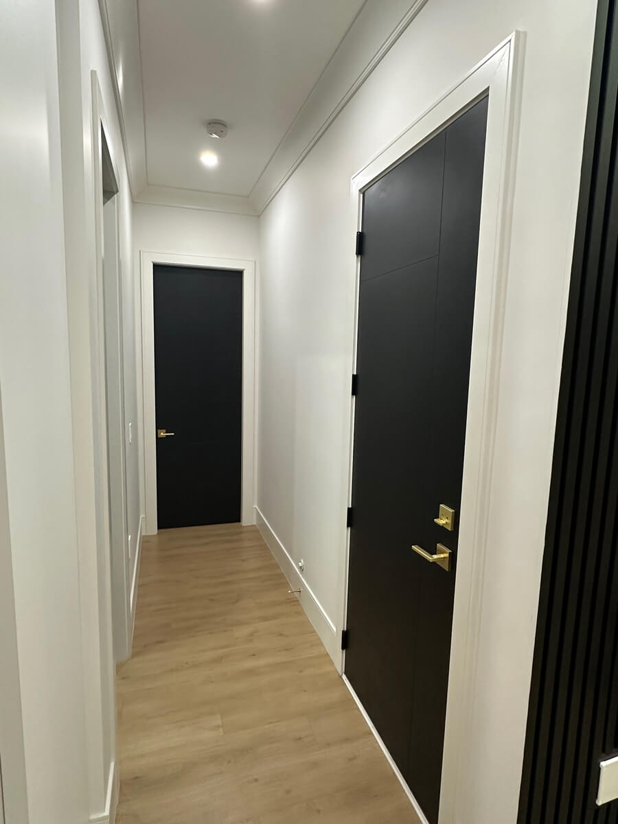 Newly painted hallway with black door home interior Oakville, Ontario