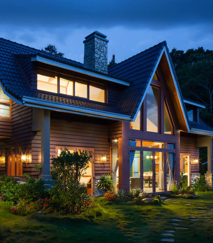 Beautiful modern chalet-style home illuminated at dusk
